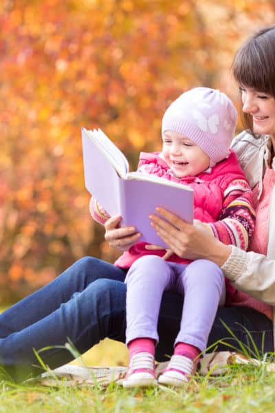 mom and toddler reading in Fall