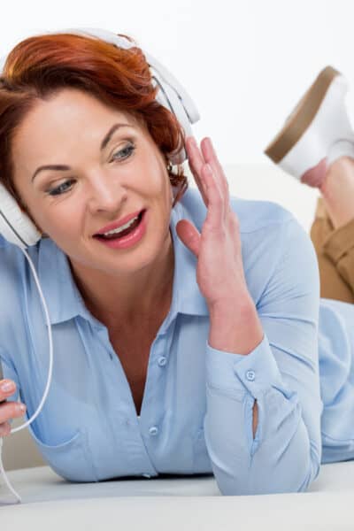 woman listening to something on her phone with headphones